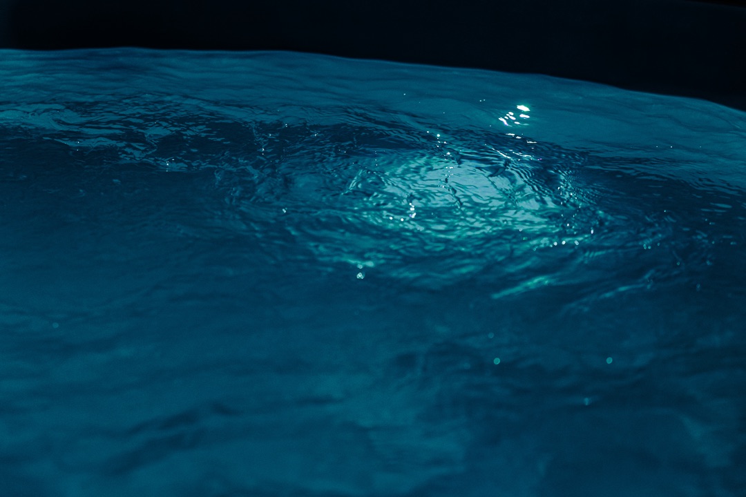 Türkis beleuchtete Wasseroberfläche